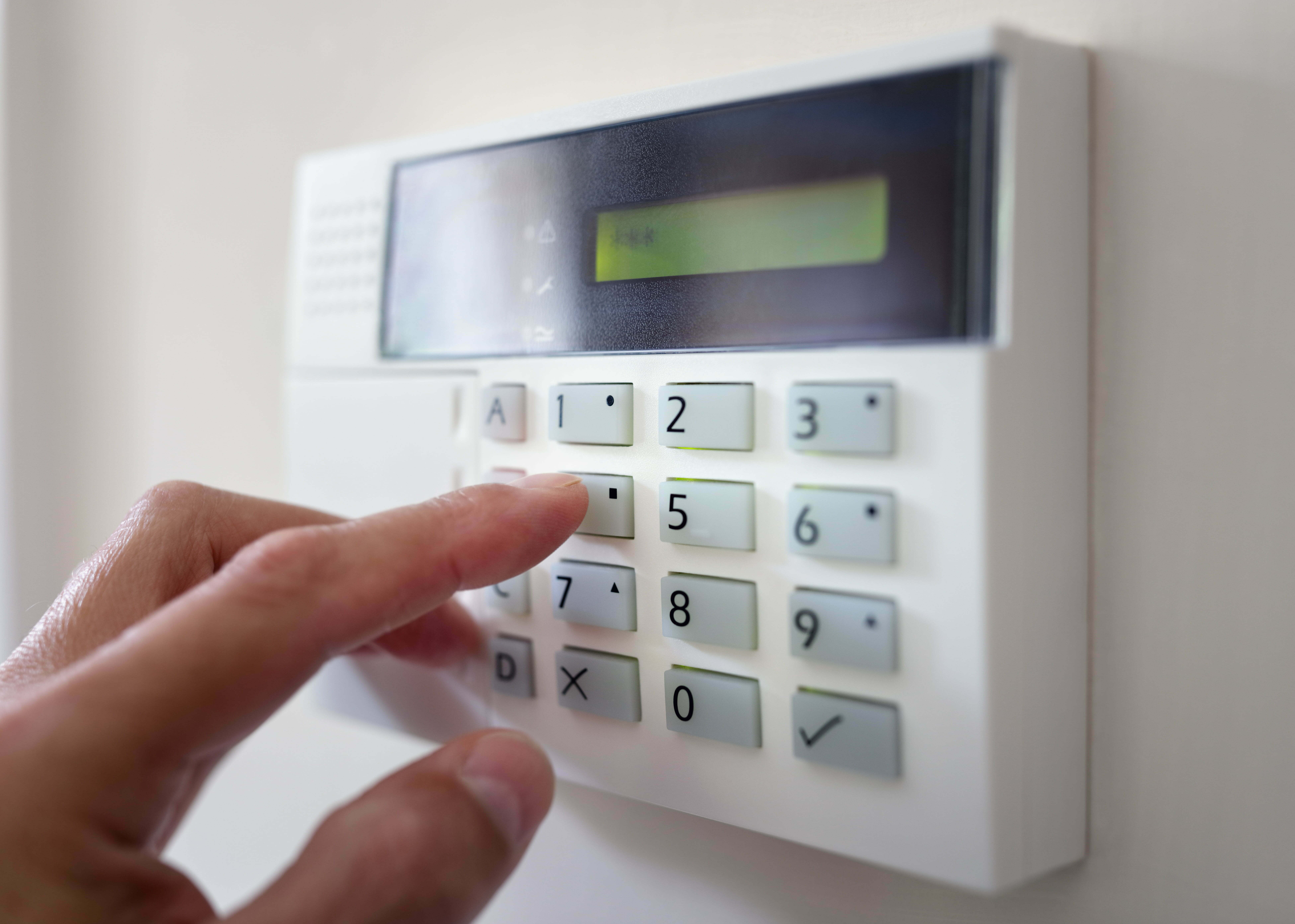Security alarm keypad with person arming the system 